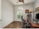 Bright office featuring a large arched window, wood floors, and a wood desk at 339 Manatee Ln, Tarpon Springs, FL 34689