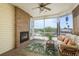 Screened in patio featuring a fireplace, a ceiling fan and views of the water at 339 Manatee Ln, Tarpon Springs, FL 34689