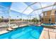 Enclosed pool and spa with tile surround and canal view at 339 Manatee Ln, Tarpon Springs, FL 34689