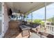 A screened porch with outdoor kitchen, TV, and water view at 339 Manatee Ln, Tarpon Springs, FL 34689