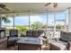 Outdoor seating on the screened porch with a view of the water at 339 Manatee Ln, Tarpon Springs, FL 34689