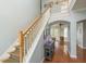 A staircase with wooden handrail leading to the upper level, with hardwood floors visible in the background at 339 Manatee Ln, Tarpon Springs, FL 34689
