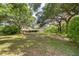 Spacious backyard with lush grass and mature trees offering privacy and room for recreation at 37348 Tucker Rd, Zephyrhills, FL 33541