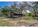 Rustic horse barn featuring multiple stalls and fenced paddocks at 37348 Tucker Rd, Zephyrhills, FL 33541