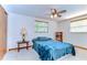 Comfortable bedroom with a ceiling fan, ample natural light, and a calming atmosphere at 37348 Tucker Rd, Zephyrhills, FL 33541
