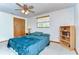 Well-lit bedroom featuring a ceiling fan, a large window, and a cozy, inviting ambiance at 37348 Tucker Rd, Zephyrhills, FL 33541