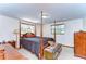 Spacious bedroom with dark wood four poster bed, abundant natural light, and a serene atmosphere for restful nights at 37348 Tucker Rd, Zephyrhills, FL 33541