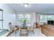 Intimate dining area with a glass table, wrought iron chairs, and sun-drenched windows showcasing the outdoor scenery at 37348 Tucker Rd, Zephyrhills, FL 33541