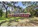 Beautiful brick home with a well-maintained lawn, surrounded by mature trees at 37348 Tucker Rd, Zephyrhills, FL 33541
