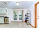 Open kitchen area with stainless steel dishwasher, plenty of shelving and a door to the outside at 37348 Tucker Rd, Zephyrhills, FL 33541