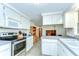 Well-equipped kitchen with ample counter space, modern appliances, and white cabinetry at 37348 Tucker Rd, Zephyrhills, FL 33541