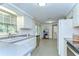 Bright kitchen with white cabinets, stainless steel appliances, and ample counter space at 37348 Tucker Rd, Zephyrhills, FL 33541