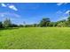 A lush grassy lot surrounded by trees, presenting an idyllic building site at 37348 Tucker Rd, Zephyrhills, FL 33541
