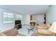 Cozy living room with a large window allowing natural light to flood the space and vintage sewing table turned decor piece at 37348 Tucker Rd, Zephyrhills, FL 33541