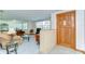Bright and airy living room features a light brick wall, entry door and a seamless flow for entertaining guests at 37348 Tucker Rd, Zephyrhills, FL 33541