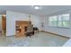 Functional home office space with built-in shelving, comfortable seating, and ample natural light for a productive environment at 37348 Tucker Rd, Zephyrhills, FL 33541