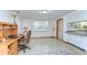 Bright office area with built-in desk, neutral decor, and a view of the outdoors creates a serene workspace at 37348 Tucker Rd, Zephyrhills, FL 33541