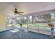 Charming screened porch with a table setting, perfect for enjoying the outdoor view and fresh air at 37348 Tucker Rd, Zephyrhills, FL 33541
