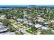 An aerial view of a quiet neighborhood with palm trees, green lawns, and a view of the city skyline at 4018 Indianapolis Ne St, St Petersburg, FL 33703