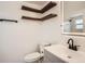 Modern bathroom featuring floating shelves and a stylish vanity at 4018 Indianapolis Ne St, St Petersburg, FL 33703