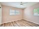 Cozy bedroom showcasing wood floors and a bright window with white blinds at 4018 Indianapolis Ne St, St Petersburg, FL 33703