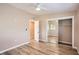 Bright bedroom features hardwood floors, closet with mirrored doors, and a ceiling fan at 4018 Indianapolis Ne St, St Petersburg, FL 33703