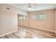 Bright bedroom featuring wood floors, ceiling fan, and a closet with mirrored sliding doors at 4018 Indianapolis Ne St, St Petersburg, FL 33703