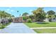 Charming single-story home with a well-maintained front yard and a gray driveway at 4018 Indianapolis Ne St, St Petersburg, FL 33703