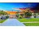 Charming single-story home with a well-manicured lawn and a long concrete driveway leading to the front door at 4018 Indianapolis Ne St, St Petersburg, FL 33703