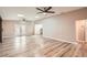 Large living room featuring wood-look floors, skylights, ceiling fans, and access to the outdoors at 4018 Indianapolis Ne St, St Petersburg, FL 33703