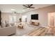 Staged living room with natural light, wood-look floors, and a comfortable seating arrangement at 4018 Indianapolis Ne St, St Petersburg, FL 33703