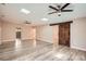 Spacious living room with wood-look flooring, skylights, ceiling fans, and a sliding barn door at 4018 Indianapolis Ne St, St Petersburg, FL 33703