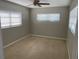 Bright bedroom with neutral carpet, a ceiling fan, and two windows providing plenty of natural light at 419 12Th Ave, Indian Rocks Beach, FL 33785