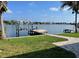 Scenic waterfront view featuring a private dock, lush lawn, and stunning bay scenery at 419 12Th Ave, Indian Rocks Beach, FL 33785