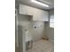 Functional laundry room featuring a utility sink, white cabinets, and ample space at 419 12Th Ave, Indian Rocks Beach, FL 33785