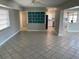 Open-concept living room with tile floors flows to the updated kitchen, creating a bright and airy space at 419 12Th Ave, Indian Rocks Beach, FL 33785