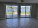 Inviting living area with sliding glass doors offering serene water views and access to the outdoors at 419 12Th Ave, Indian Rocks Beach, FL 33785