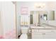Bathroom featuring a toilet, vanity with sink and framed butterfly art at 4204 W San Juan St, Tampa, FL 33629