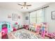 Bright bedroom featuring playful decor, a colorful rug, and natural light streaming through the window at 4204 W San Juan St, Tampa, FL 33629