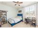 Well-lit bedroom with a window, ceiling fan, and gray carpet at 4204 W San Juan St, Tampa, FL 33629