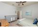 Comfortable bedroom features a ceiling fan, neutral walls, and dresser with attractive hardware at 4204 W San Juan St, Tampa, FL 33629