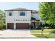 Charming two-story home featuring a brick driveway, three-car garage, and manicured landscaping at 4204 W San Juan St, Tampa, FL 33629