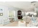 Open-concept living room with comfortable seating, a stylish bar area, and views into the kitchen at 4204 W San Juan St, Tampa, FL 33629
