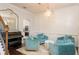 Sitting room features an elegant chandelier, wainscotting, piano, and comfortable blue armchairs at 4204 W San Juan St, Tampa, FL 33629