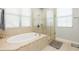 This bathroom boasts a soaking tub with a glass shower enclosure and bright windows at 4204 W San Juan St, Tampa, FL 33629