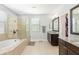 This spa-like bathroom has a soaking tub, separate shower, and dual vanities at 4204 W San Juan St, Tampa, FL 33629