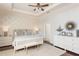 This main bedroom features a tray ceiling, neutral decor, hardwood floors, and updated furniture at 4204 W San Juan St, Tampa, FL 33629