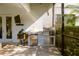 Outdoor kitchen featuring stainless steel grill, refrigerator, and TV for entertaining at 4204 W San Juan St, Tampa, FL 33629
