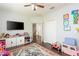 Spacious playroom features a ceiling fan, wood floors, closet, and lots of space for toys at 4204 W San Juan St, Tampa, FL 33629
