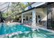 This screened-in pool area offers an outdoor kitchen and seating with plenty of room for entertaining at 4204 W San Juan St, Tampa, FL 33629